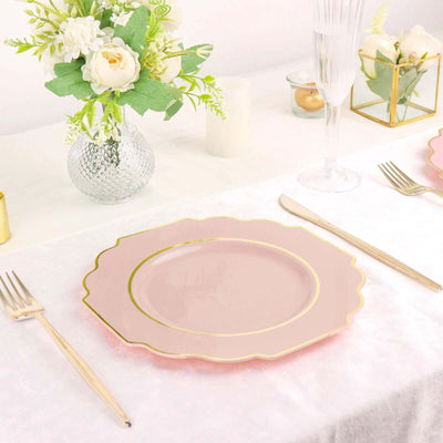 Elegant pink plate with gold trim set on a beautifully arranged table.