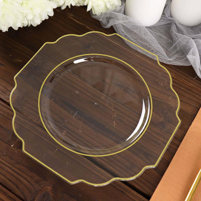 Clear scalloped edge plate with yellow trim on wooden background.