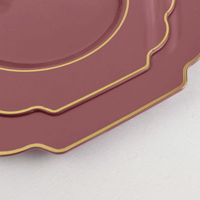 Elegant maroon plates with gold trim, stacked together.