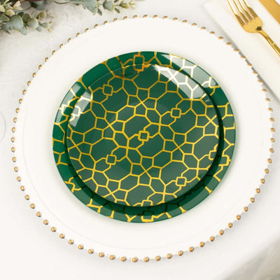 Green decorative plate with gold geometric pattern on a white table setting.