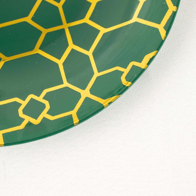 Green plate with yellow geometric pattern
