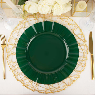 Green decorative plate on a gold wire charger with elegant table setting.