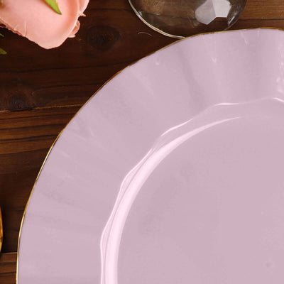 Pastel pink plate with gold rim on a wooden table.