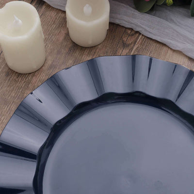Navy blue plate with fluted edges, styled with candles and a textured backdrop.