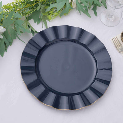 Navy blue decorative plate with a scalloped edge on a table setting.
