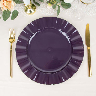 Purple ruffled dinner plate on a table setting with gold cutlery.