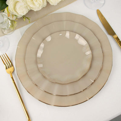 Elegant beige dinnerware set with gold trim on a table setting.