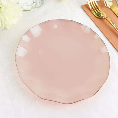 Pink scalloped plate on a textured surface.