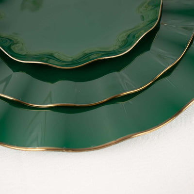 Green decorative plates with gold trim, stacked in a stylish arrangement.
