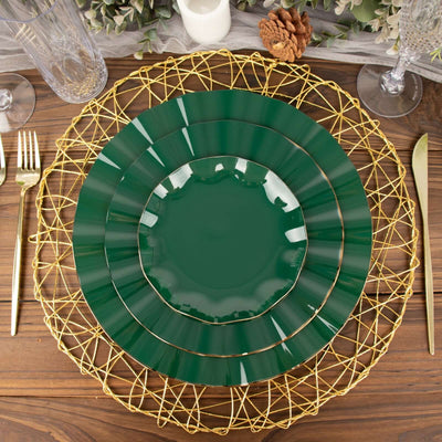 Green plates on a decorative gold charger, set on a wooden table.