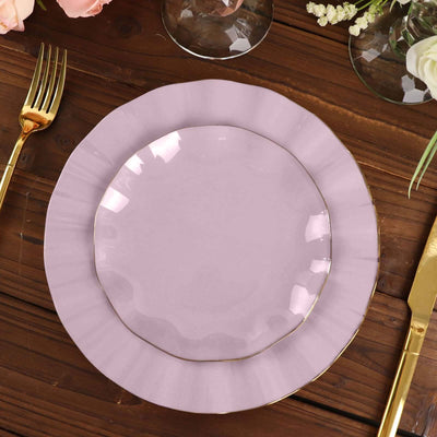 Elegant lavender plate with gold trim on a wooden table setting.