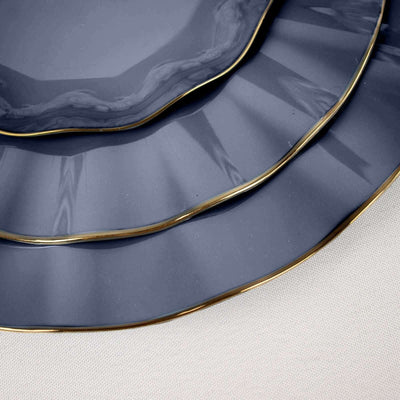 Elegant navy blue plates with gold trim in a stacked arrangement.