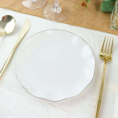 Elegant white plate with gold trim, set on a textured table runner.