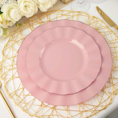 Elegant pink plates on a decorative gold charger with floral accents.