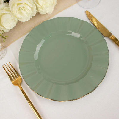 Elegant green plate with gold rim, set with fork and knife.