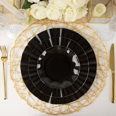 Elegant black plate set with gold accents on a decorative gold charger.