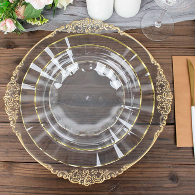 Elegant clear plate with gold trim on rustic wooden table setting.