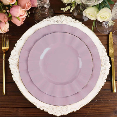 Elegant lavender plates on a beautifully set table with floral arrangements.