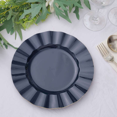 Navy blue decorative plate with a scalloped edge on a white table setting.