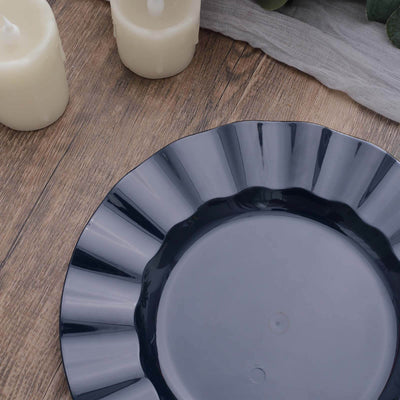 Dark gray decorative plate on a wooden surface with candles.