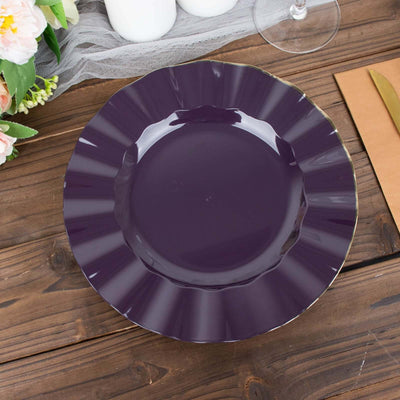 Purple decorative plate with a scalloped edge on a wooden table.
