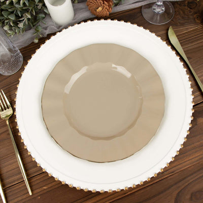 Elegant beige plate on a decorative white charger with gold accents.