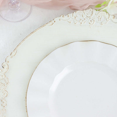 Elegant white plate on decorative charger with vintage design.