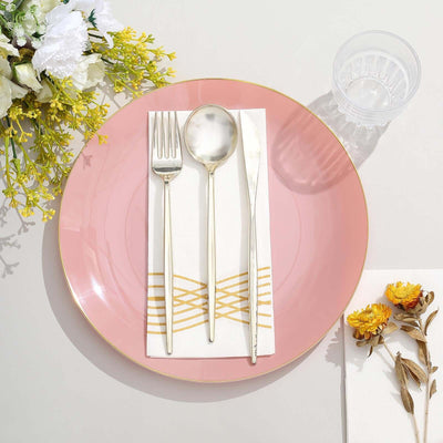 Elegant pink plate with silver cutlery and decorative napkin.
