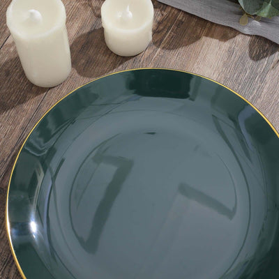 Dark green decorative plate with a gold rim on a wooden surface.