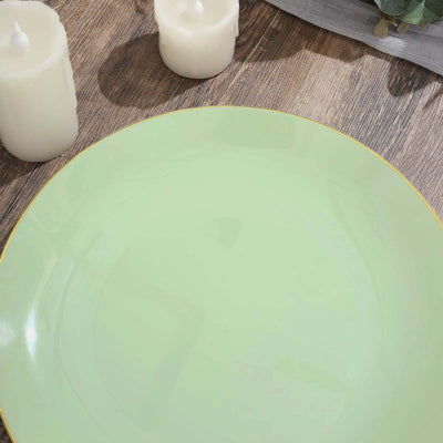 Green ceramic plate with a gold rim on a wooden surface.