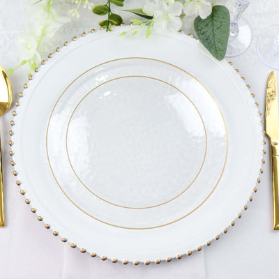 Elegant white plate with gold rim and beaded accents, styled for dining.