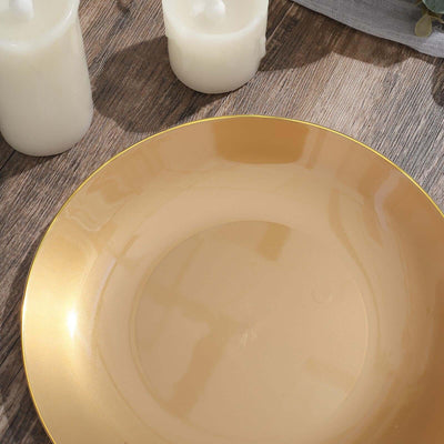 Gold decorative plate on a wooden surface with candles.