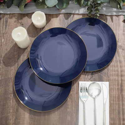 Elegant navy plates with gold rim on rustic wooden table setting.