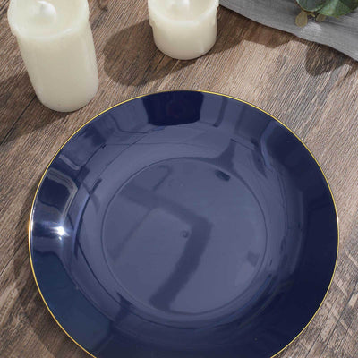 Navy blue plate with gold rim on wooden surface