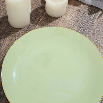 Green plate with gold rim on wooden surface, surrounded by white candles.