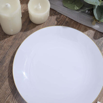 Elegant white plate with gold rim on wooden table