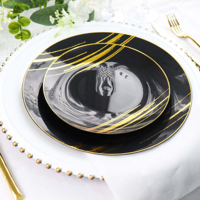Elegant black and gold dinner plates stacked on a beautifully set table.