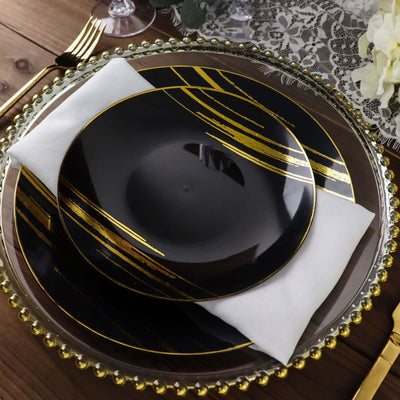 Elegant black plate with gold stripes on a stylish table setting.