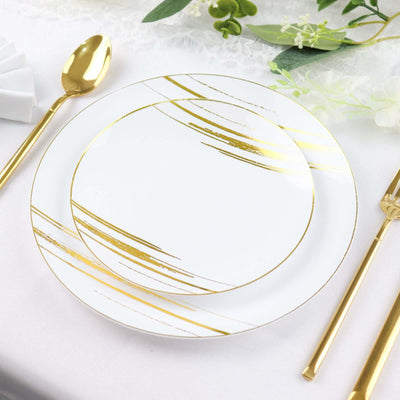 Elegant white plate with gold stripe design on a stylish table setting.