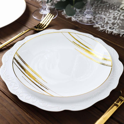 Elegant white plate with gold accents on a wooden table setting.