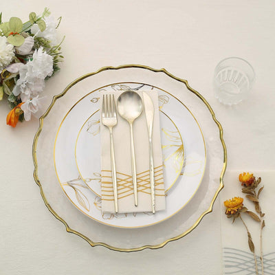 Elegant dining set with floral plates, silverware, and decorative napkin on a table.