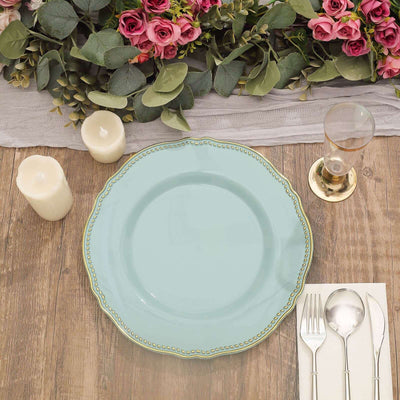 Elegant aqua plate set on a rustic table with candles, glass, and floral decor.
