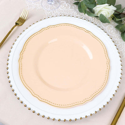 Elegant peach dinner plate with scalloped edges on a decorative charger.