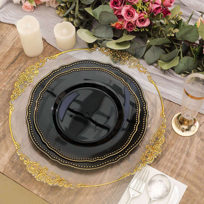 Elegant black plate with gold trim on a rustic wooden table setting.