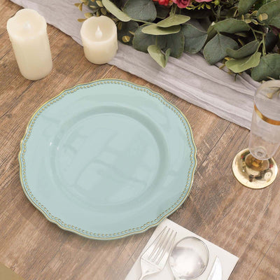 Elegant turquoise plate with gold trim on a rustic wooden table setting.