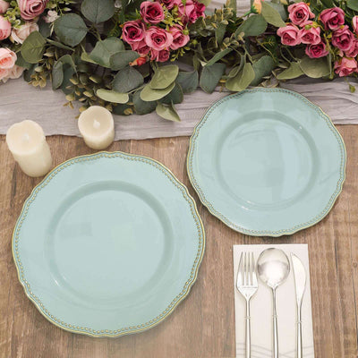 Elegant mint green plates on a rustic wooden table with floral decor.