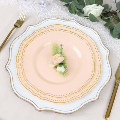 Elegant pink plate with floral decoration on a lace table setting.