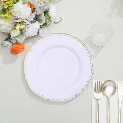 Elegant white plate with gold trim on a table setting.