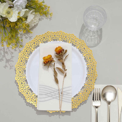 Elegant table setting with gold lace plate charger and floral napkin decoration.
