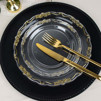 Elegant black plate with gold-accented clear plate and gold cutlery.
